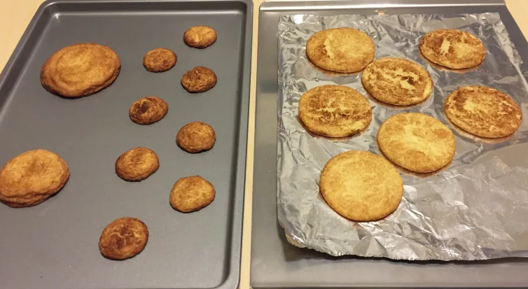 burned cookies on a baking pan next to cookies on aluminum foil