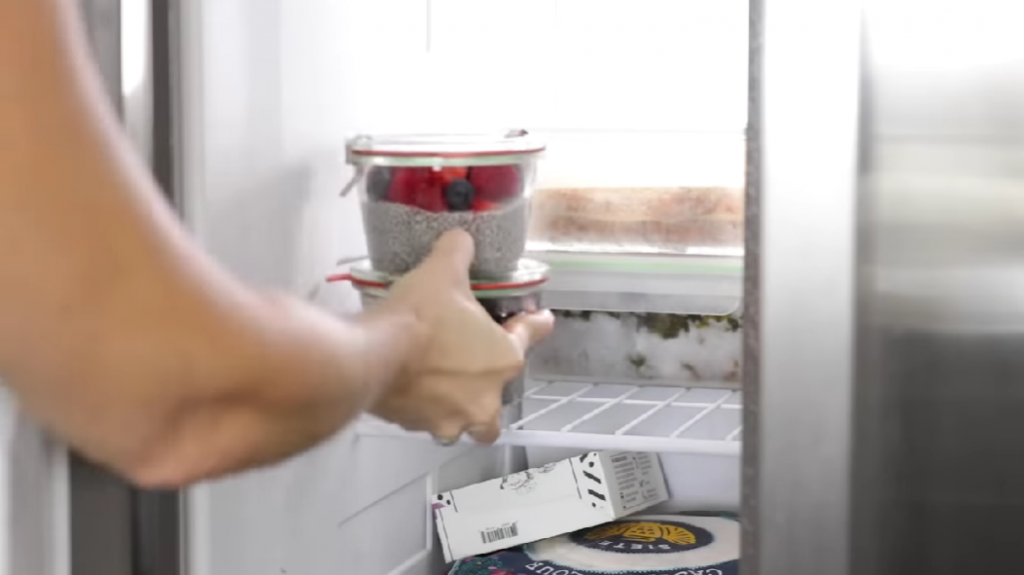 woman putting pudding in the freezer